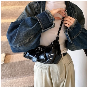 Chic black glossy Y2K shoulder bag with silver studs and adjustable metal hardware