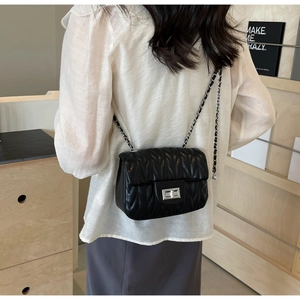 Classic black quilted crossbody bag with silver chain strap and metal lock detail