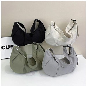 Detailed display of four nylon dumpling bags in black, beige, green, and gray colors