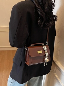 Dark brown leather small square handbag with top handle and woven tassel charm for women