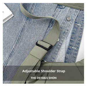 Detail of adjustable olive green fabric shoulder strap with black buckle and reinforced stitching