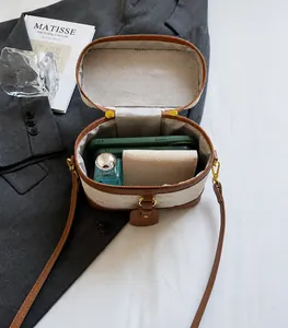 Top-down view of a vintage mini box bag interior showing phone and wallet storage