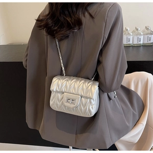 Silver V-quilted crossbody bag with metallic finish and elegant chain strap detail