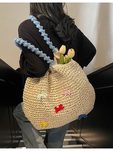 Large woven straw beach tote bag with colorful 3D bows and blue plush handle