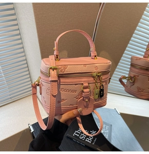 Detail of pink lychee grain PU leather box bag with floral butterfly embossing and gold hardware