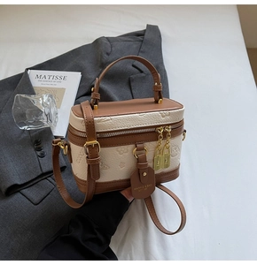 Detailed macro view of floral embossed leather with elegant gold zipper and brown handles