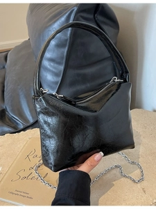 Black glossy pleated leather bucket bag with silver chain strap and top handle