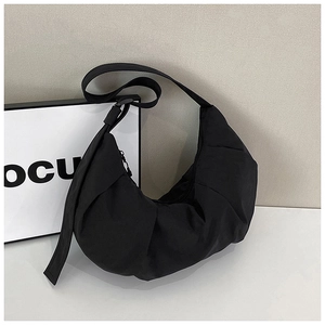 Detailed view of the pleated nylon texture and zipper closure on this black crescent bag