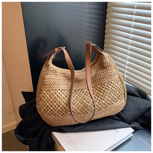 Fashionable straw woven shoulder bag with brown leather strap and hollow crochet design