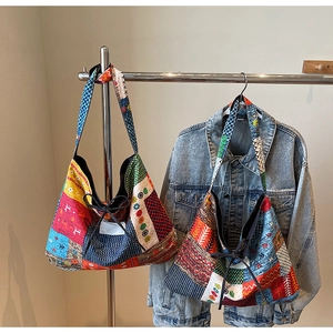 Detail of bohemian patchwork tote bag with floral patterns and a decorative drawstring bow