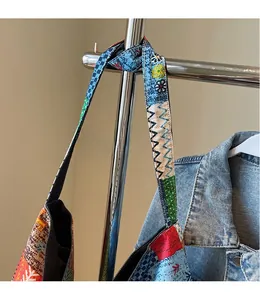 Close-up of wide patterned straps and bohemian canvas tote bag on display rack