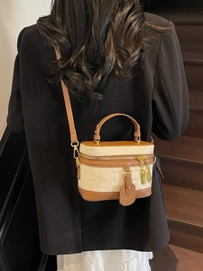 Brown leather crossbody bag with butterfly relief carving and adjustable strap