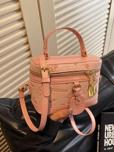 Pink box-shaped crossbody bag with embossed butterfly and flower patterns and metal lock