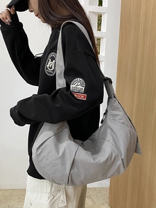 Fashionable grey oversized crescent crossbody bag in glossy nylon for daily commute