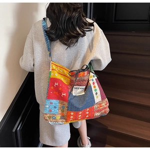 Detail of bohemian canvas tote bag showing ethnic embroidery patterns and SEEYOU brand label