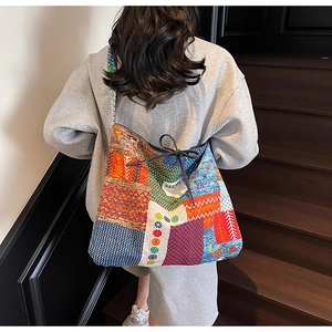 Detail of colorful patchwork canvas tote bag with ethnic patterns and drawstring closure