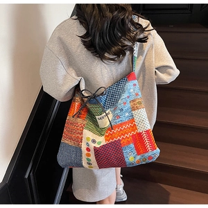 Detail view of ethnic patchwork canvas tote bag with drawstring and brand label