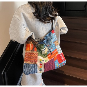 Macro view of patchwork canvas tote bag with floral patterns and drawstring detail