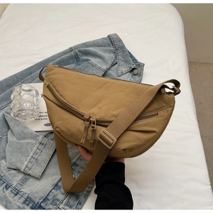 Detail of khaki crescent crossbody bag with double zipper and adjustable strap