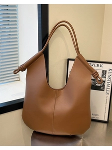 Minimalist large brown hobo tote bag in matte leather with knot shoulder strap details