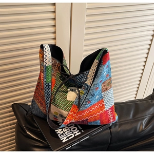 Detail of colorful patchwork tote bag with bohemian geometric patterns and drawstring closure