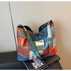 Detail of bohemian patchwork tote bag featuring vibrant patterns and SEEYOU woven label
