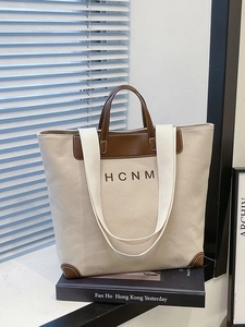 Minimalist canvas tote bag with brown leather trim and HCNM embroidery