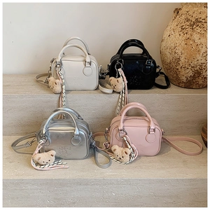 Minimalist pillow bags in four colors with luxury charms and embossed branding