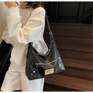 Close-up of black tote bag featuring metallic silver zippers and Noronoro brand logo