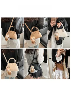 Detailed views of multi-color semi-circular leather handbags with cute bear charm accents