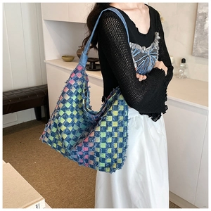 Detail of multi-color rainbow checkered denim tote bag with stylish fringe edges