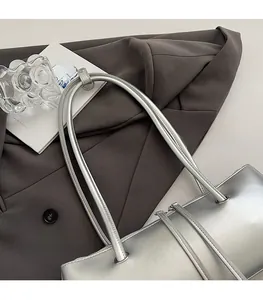 Detailed top view of silver leather baguette bag showing comfortable double shoulder straps