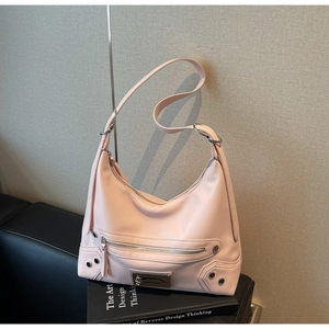 Detail of pink leather hobo bag with motorcycle style silver studs and zipper accents