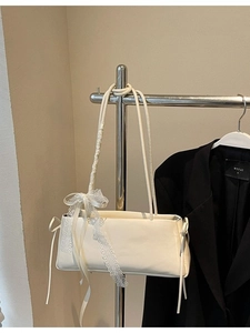 Minimalist cream shoulder bag with elegant white lace and ribbon bow details