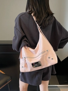 Pink PU leather tote bag with metallic studs and zipper detail shown on a model back