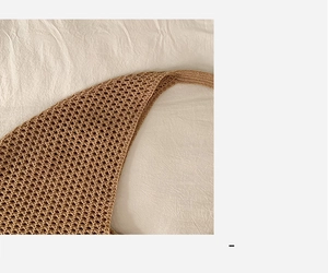 Close-up of beige woven tote bag showing detailed openwork crochet mesh and cotton texture
