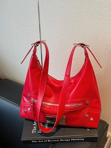 Minimalist red leather tote bag with silver studs and ring detail in a hobo style