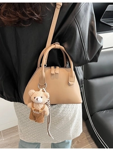 Minimalist beige bowling handbag with adjustable strap and cute plush bear charm