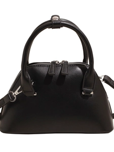 Minimalist black matte leather bowling handbag with silver hardware and adjustable strap
