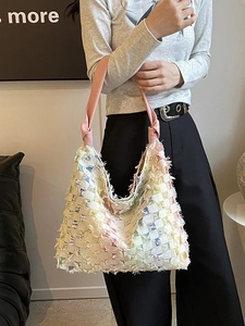 Handmade woven tote bag with colorful fringe textures and pink leather straps