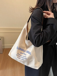 Grand sac cabas en toile blanc cassé avec anses en cuir marron et lettrage bleu vintage