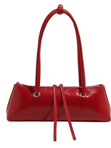 Glossy red patent leather baguette bag with dual handles and sleek minimalist structure