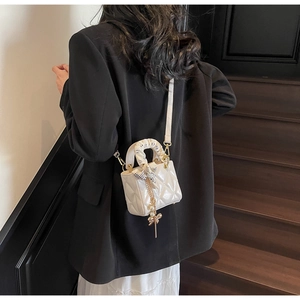 Mini white quilted handbag with silk scarf handle and pearl charm detail