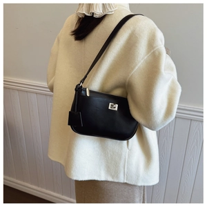 Close-up of black matte faux leather bag featuring a square silver metal lock and strap