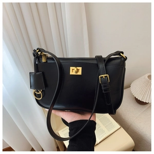 Close-up of black rectangular shoulder bag featuring gold twist lock and elegant hardware