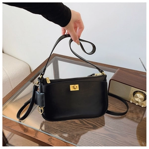 Detail of a black half-moon shoulder bag with golden twist lock and metallic zipper