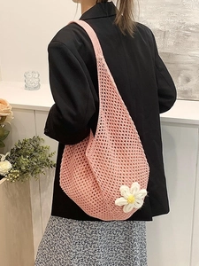 Pink crochet hollow-out tote bag with a white daisy floral accent for beach vacations