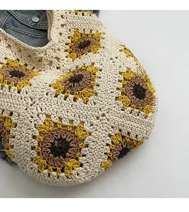 Close-up of handmade sunflower crochet tote bag with detailed yellow floral knit patterns