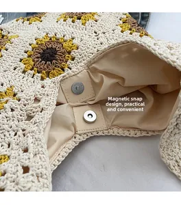 Detail view of woven straw bag showing secure magnetic closure and sunflower crochet
