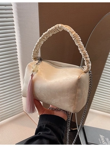 Elegant cream pleated pillow shoulder bag with silver chain strap and pink tassels